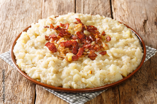 Homemade potato and barley mulgipuder with onion and bacon close-up in a plate on the table. horizontal
