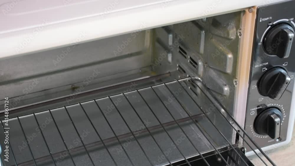 Inserting the cake tray into the oven.Top view Inserting the cake tray into the oven.Top view