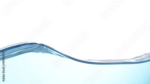 Waves of blue water on white background, close-up