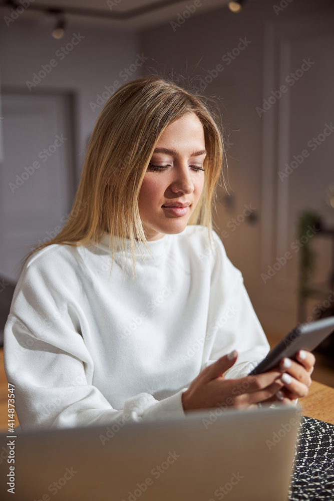 Woman ending a phone call and looking at screen Woman ending a phone call and looking at screen