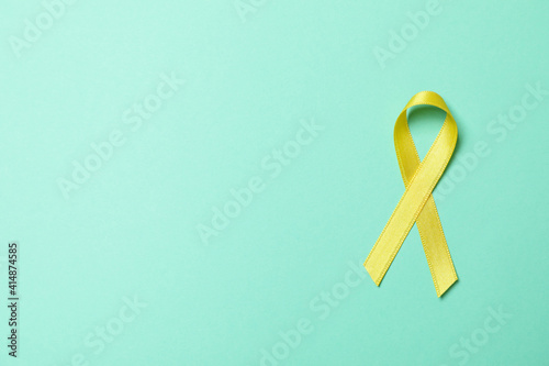 Childhood cancer awareness ribbon on mint background