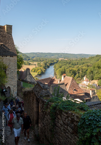  Tourists in the cobbled streets of Beynac et Cazenac village, the Dordogne, France