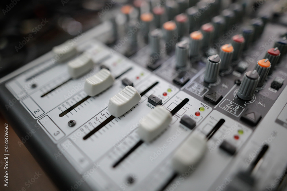 Shallow depth of field (selective focus) image with the controls on an audio mixer