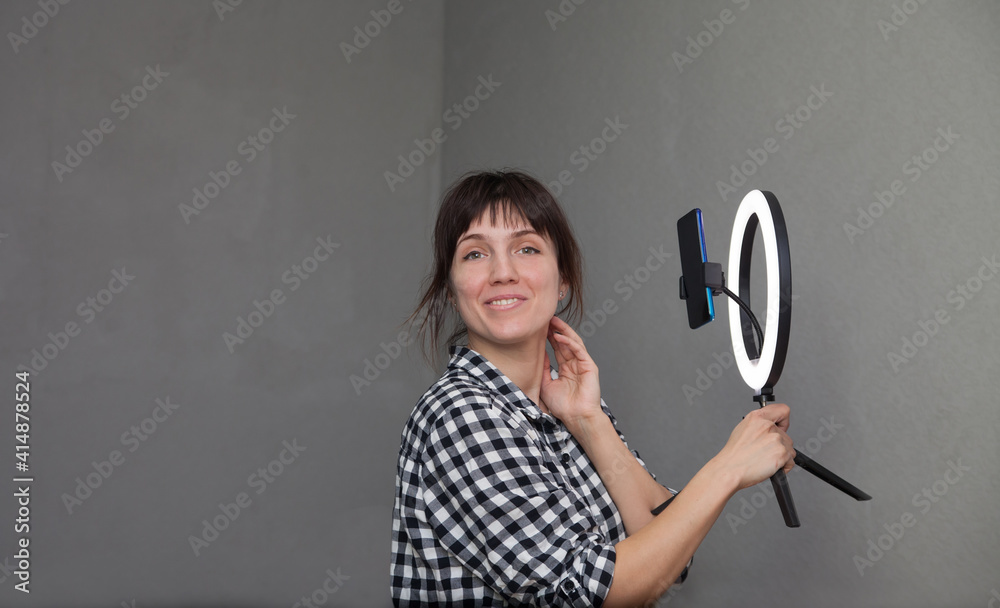 Female blogger leads live broadcast and lights herself with ring lamp Female blogger leads live broadcast and lights herself with ring lamp