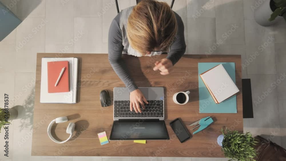 woman working from home at her desk opens laptop computer top view overhead shot,zoom out of businesswoman opening notebook and start typing writes email surfs the internet drinks coffee