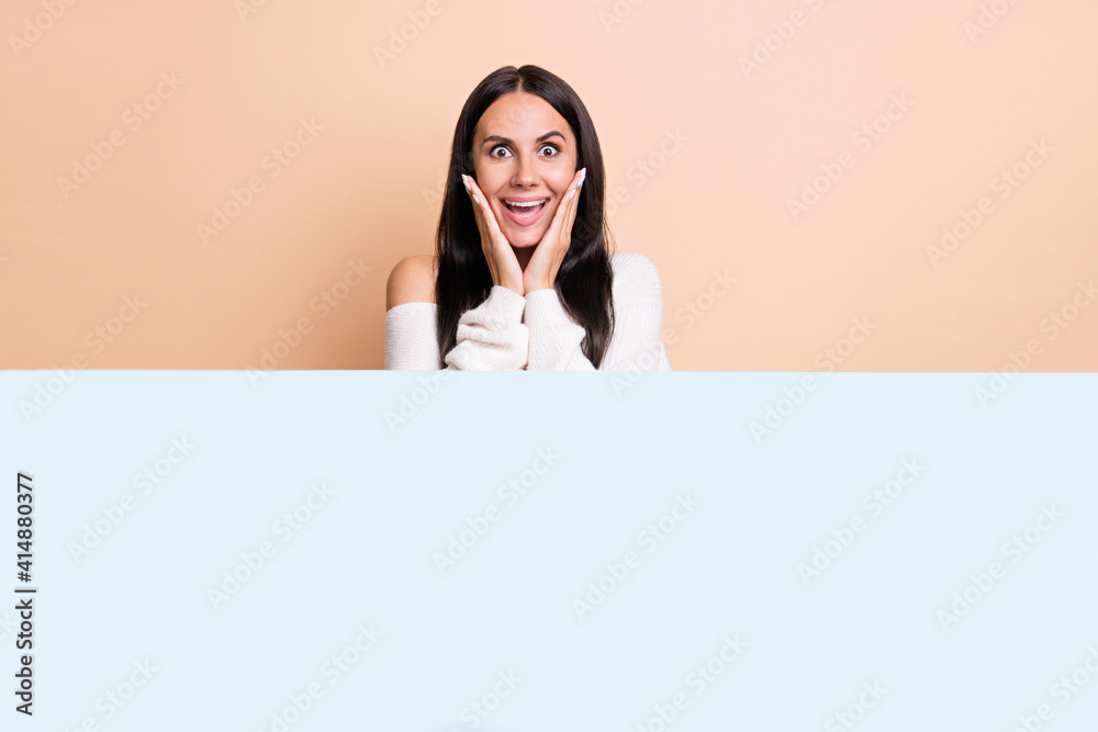 Photo of young excited girl happy positive smile amazed shocked promo advert offer banner isolated over beige color background Photo of young excited girl happy positive smile amazed shocked promo advert offer banner isolated over beige color background