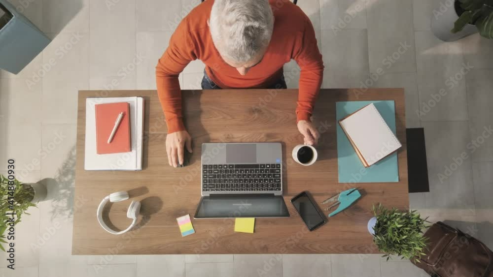 man working from home at her desk opens laptop computer top view overhead shot,zoom out of businessman opening notebook and start typing writes email surfs the internet drinks coffee