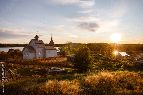 Russian village Orthodox church at sunset