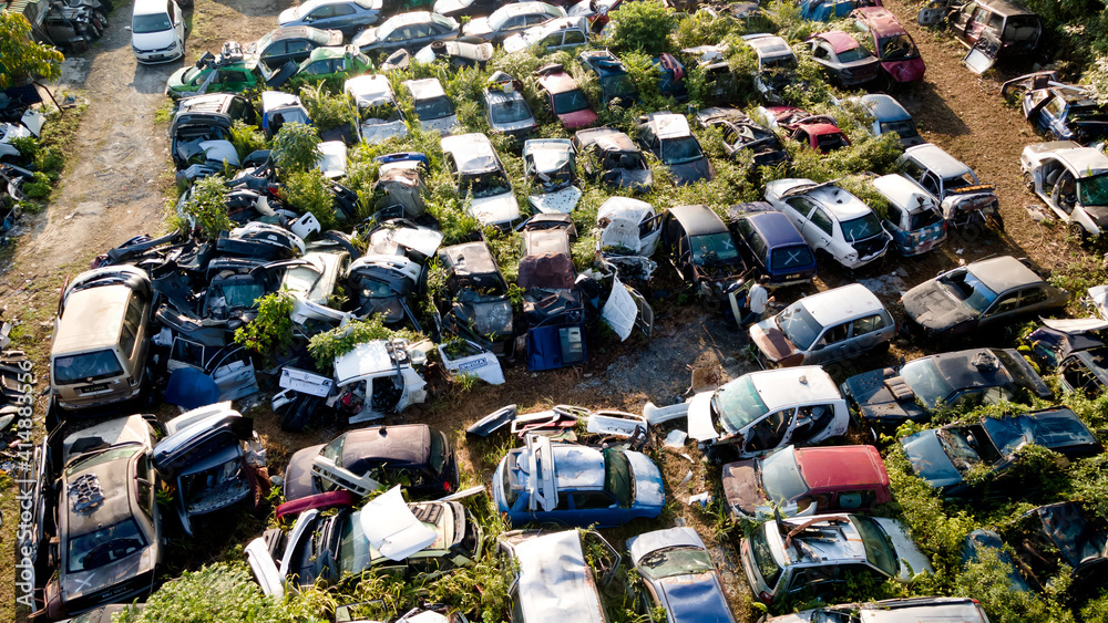 Fototapeta premium Scrapyard Aerial View. Old rusty corroded cars in car junkyard. Car recycling industry from above.