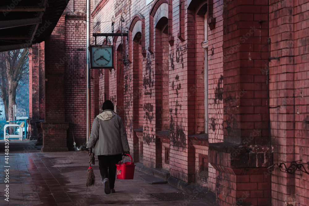 cleaning woman at the old train station