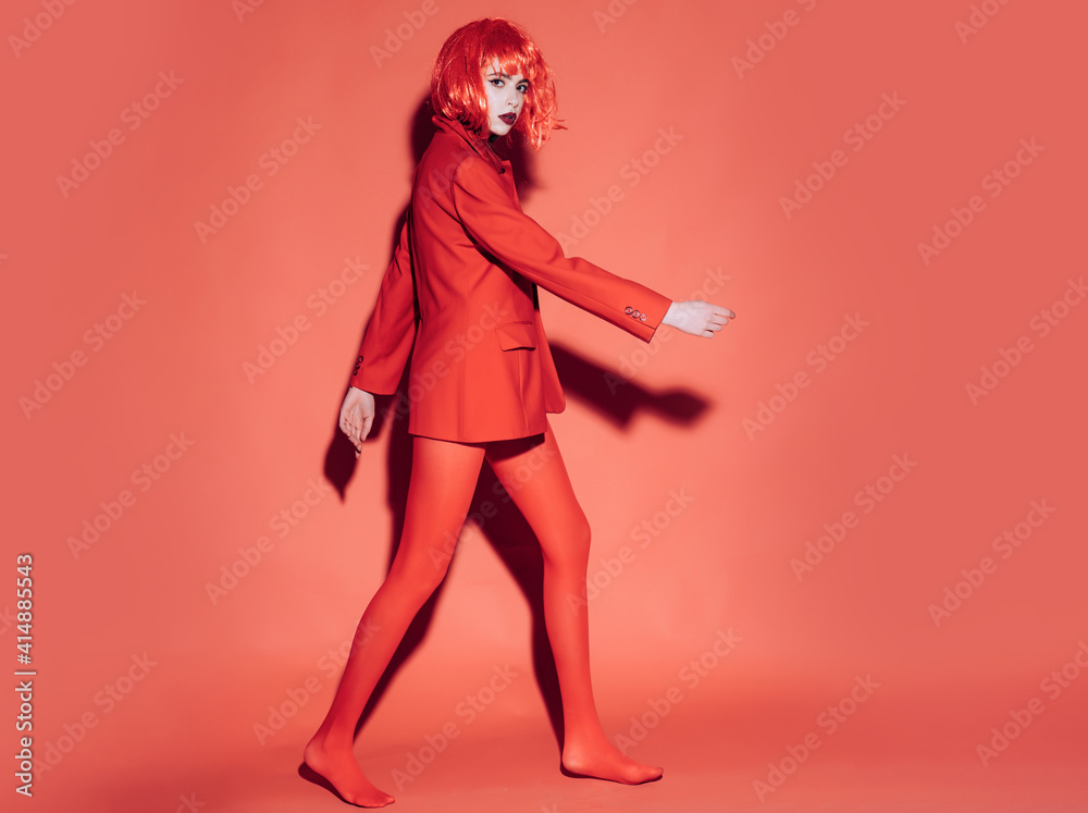 Woman in red. Fashion concept. Girl on mysterious face in red formal jacket, red background. - obrazy, fototapety, plakaty 