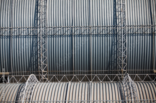 Galvanized metal hangar wall. Close-up abstract texture view. Storage industrial building. 