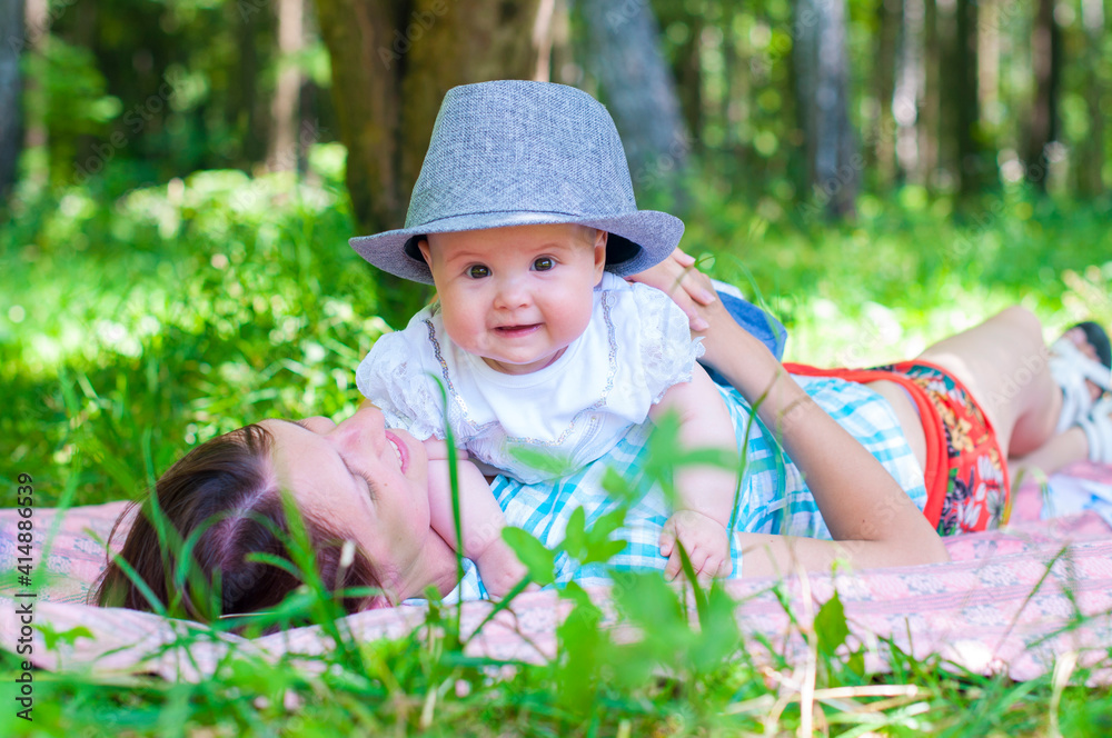 Little girl with mother in the park. Summer in the park Little girl with mother in the park. Summer in the park