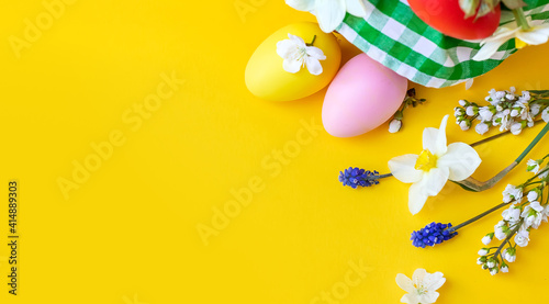 Happy Easter with flowers on a yellow background. Celebration. Selective focus.