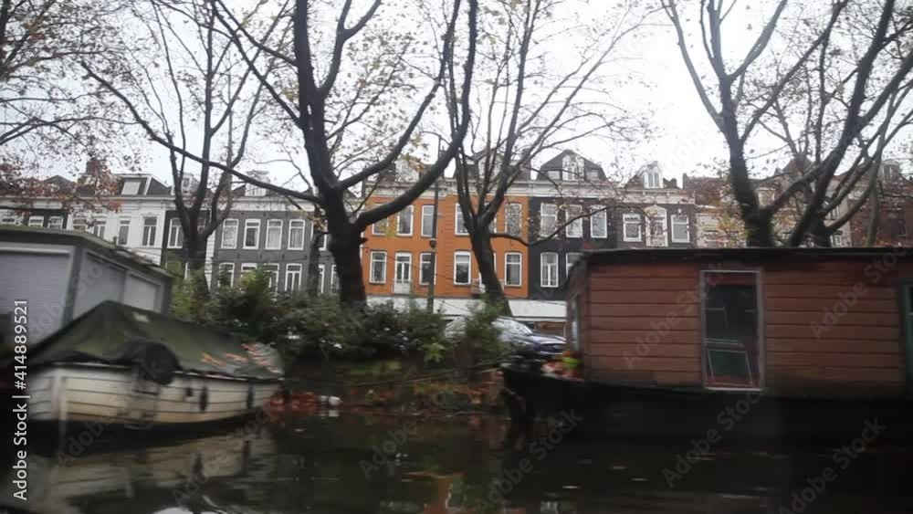 View of Amsterdam canals from a boat, canal houses, buildings, bicycles View of Amsterdam canals from a boat, canal houses, buildings, bicycles