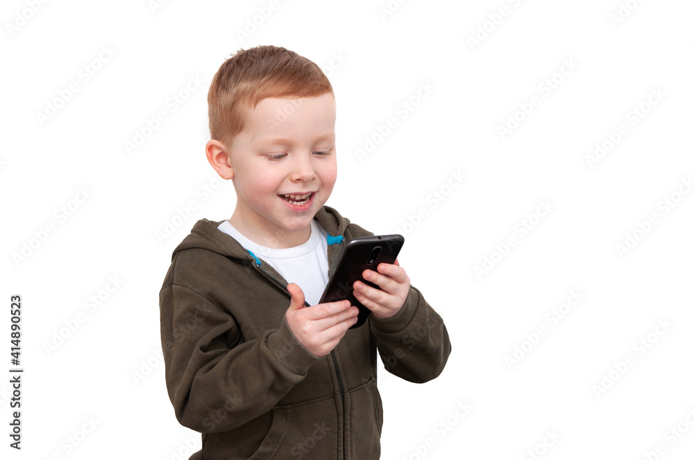 Red hair boy in stylish casual clothing standing, looking at smartphone screen and smiling, isolated on white Red hair boy in stylish casual clothing standing, looking at smartphone screen and smiling, isolated on white