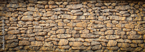 old solid wall of rough stones in Europe