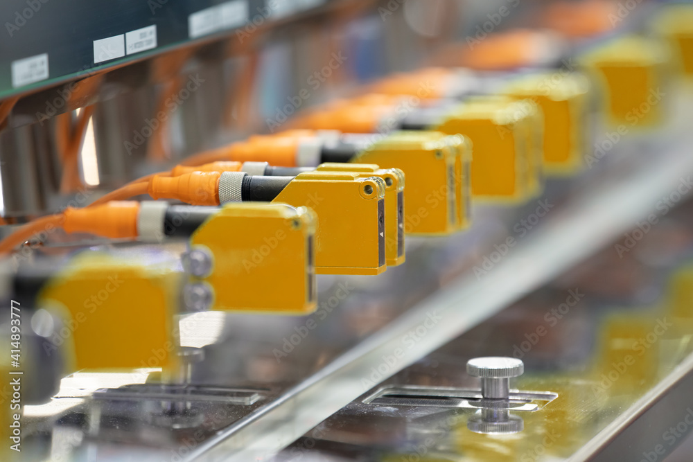 Photoelectric Sensor installed in a row of industrial machine in a factory.  Photo sensor for object detection in machine factory. foto de Stock | Adobe  Stock