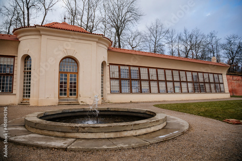 Baroque white benedictine monastery Brevnov with church, Garden Orangery with large windows and park, abbey under snow in winter day, Prague, Czech Republic photo