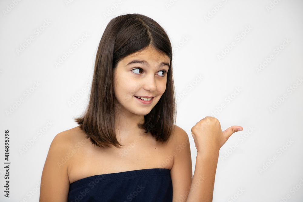 Girl, schoolgirl expresses emotions, indicates the direction close-up on a white background Girl, schoolgirl expresses emotions, indicates the direction close-up on a white background