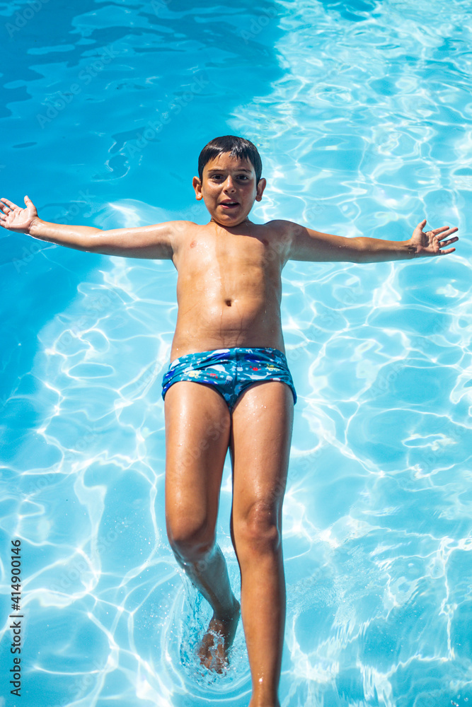 Young boy jumping on a pool Young boy jumping on a pool