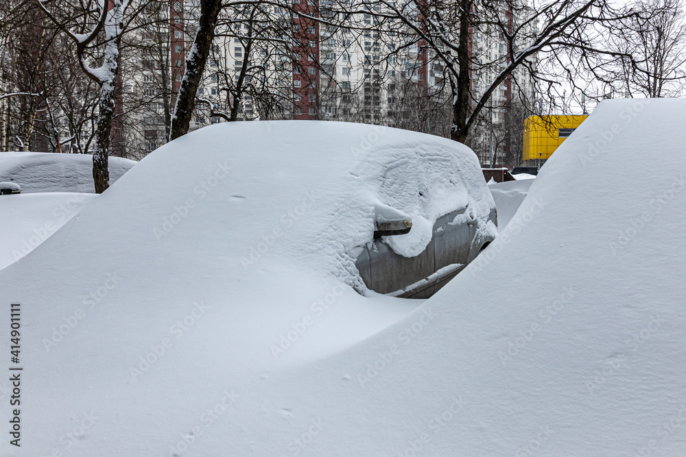 Cars under large snow drifts, after a snow storm Cars under large snow drifts, after a snow storm