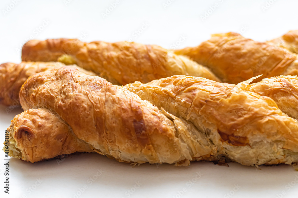Crispy golden crust of fresh pastries, in the form of a braided pigtail