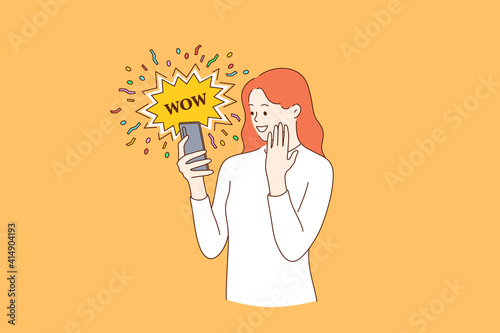 Surprise, shocking news, internet concept. Young smiling female blogger reading shocking news in message on mobile phone using network connection on smartphone with emotional wow word