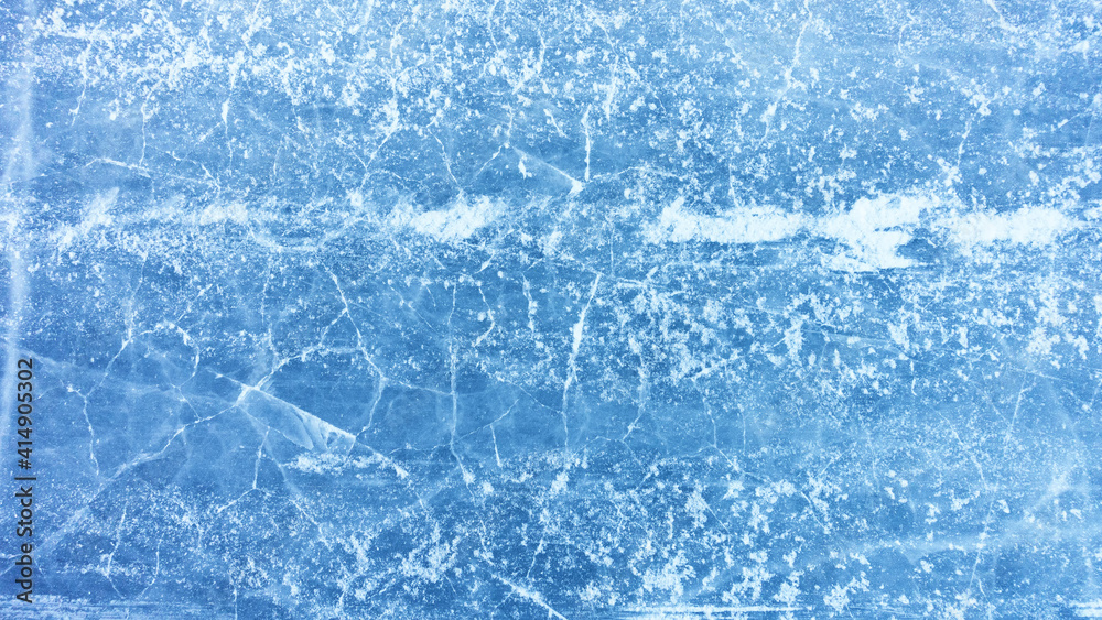 Abstract blue ice background with cracks on the surface