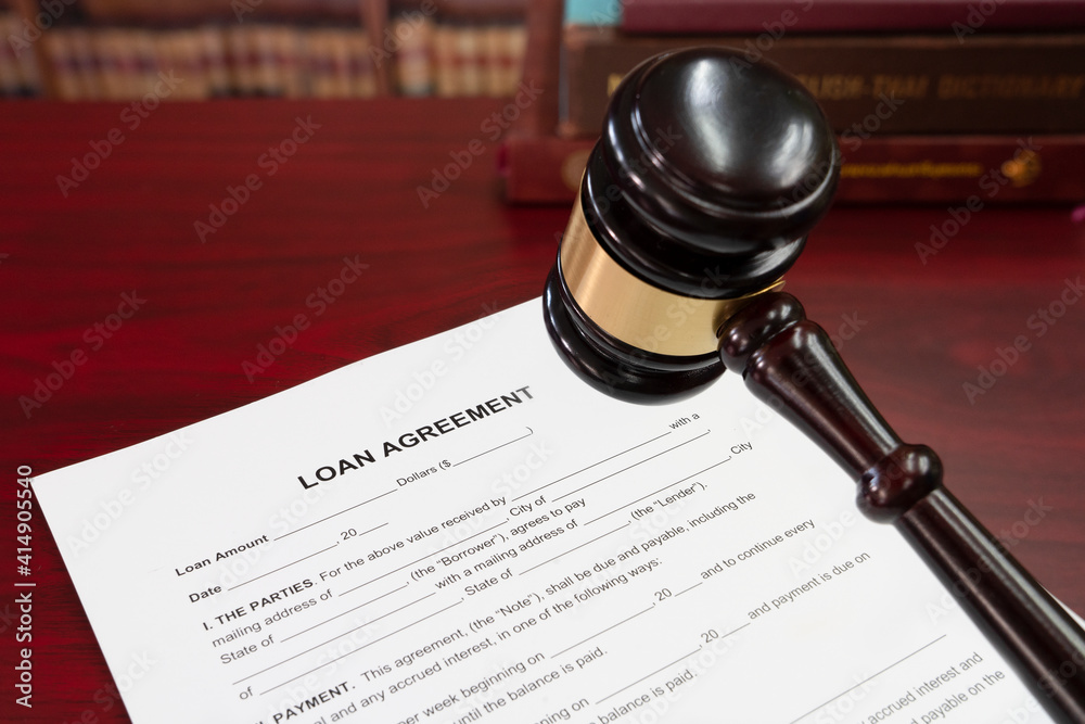 Law, loan in business concept. Gavel with business loan agreement as legal document concept. Gavel with loan agreement contract preparation for filling.