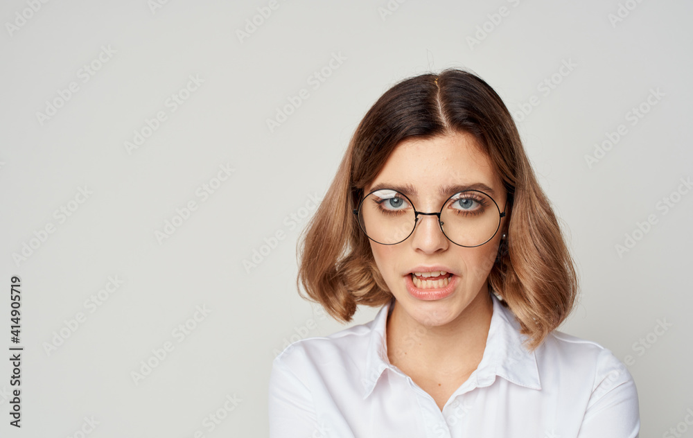 Beautiful woman wearing glasses short hair white shirt and beige background