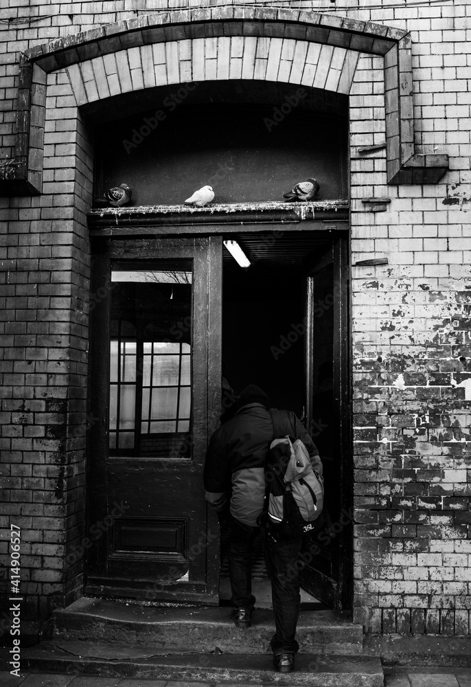 man entering the old brick building
