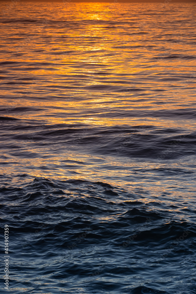 Sea waves water texture at sunrise
