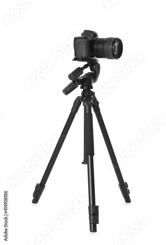 Modern tripod with camera isolated on white