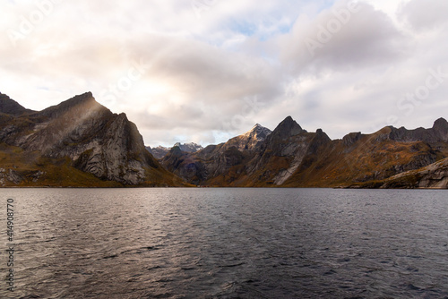 Norwegian landscape with Nordfjord fjord  mountains  forest and glacier in Reine  Norway - the photo was taken from a boat - sunshine and light rays