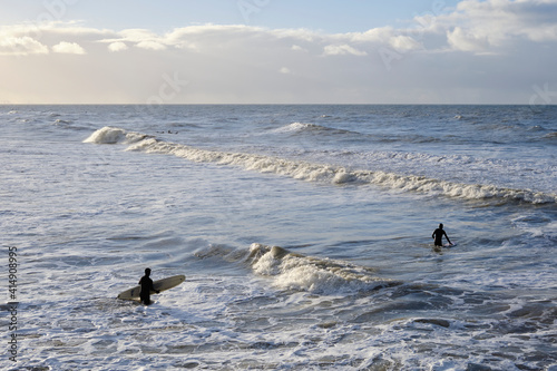 Surfers go into the sea