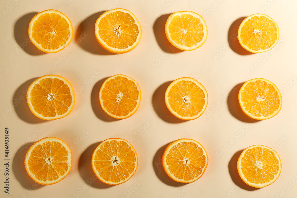 Slices of delicious oranges on beige background, flat lay Slices of delicious oranges on beige background, flat lay