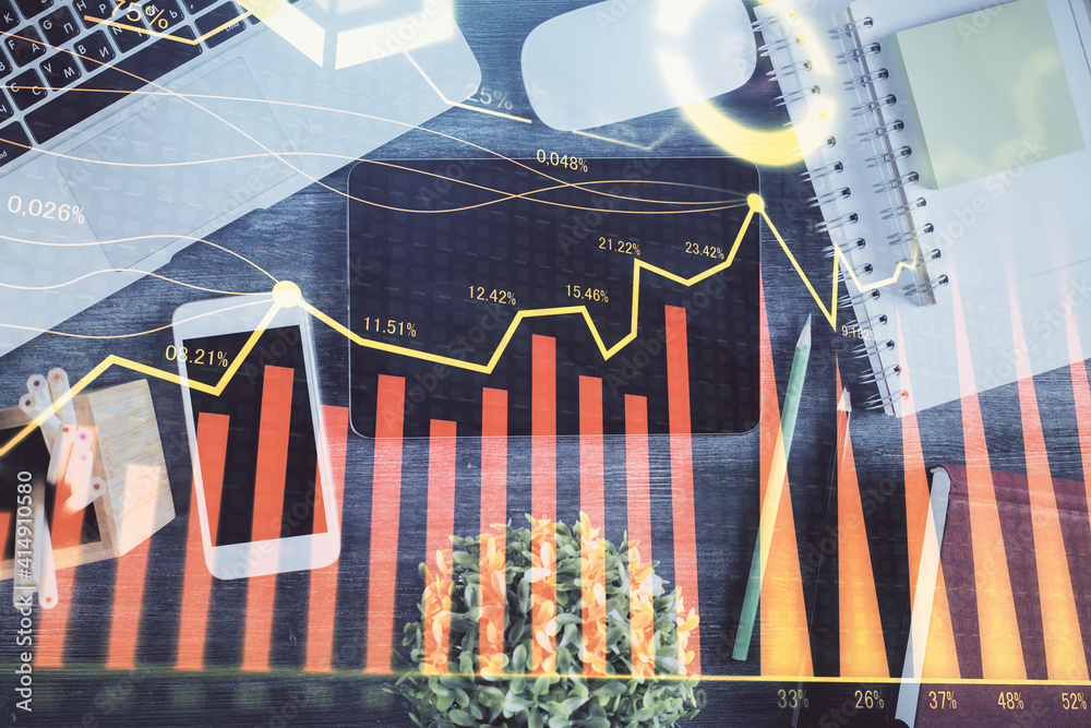 Double exposure of forex chart hologram over desktop with phone. Top view. Mobile trade platform concept. Double exposure of forex chart hologram over desktop with phone. Top view. Mobile trade platform concept.