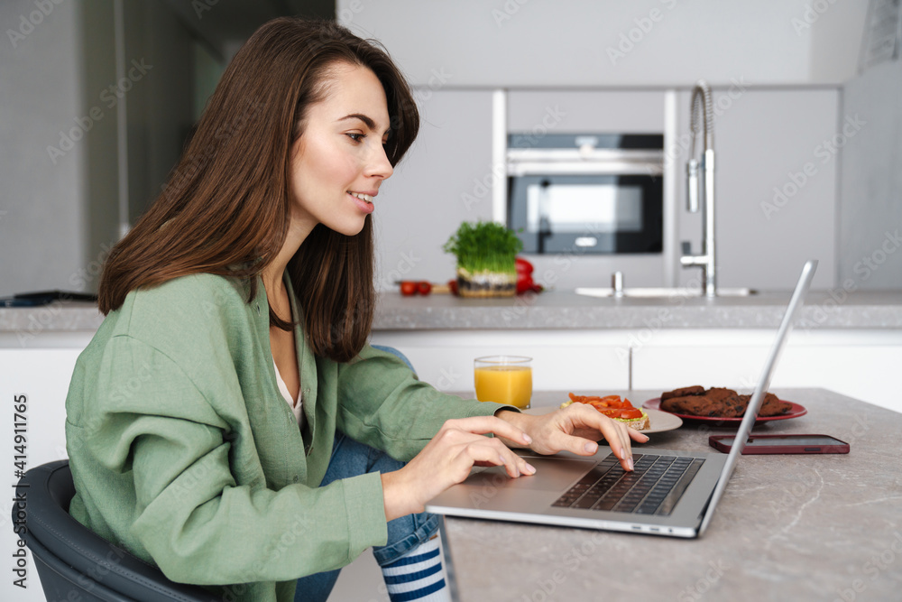 Attractive young woman working on laptop Attractive young woman working on laptop
