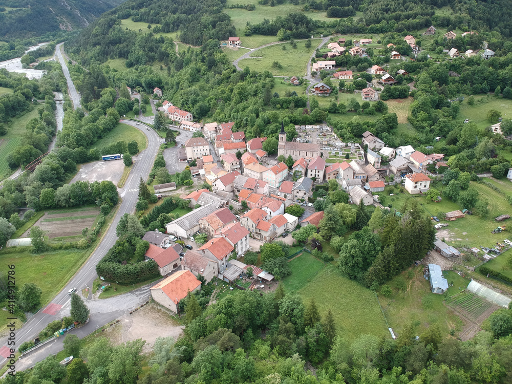 Aerial shot of a community on the hill with living houses and forests