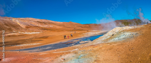 Panoramic view over colorful geothermal active zone Hverir near Myvatn lake in Iceland, resembling Martian red planet landscape, at summer and blue sky