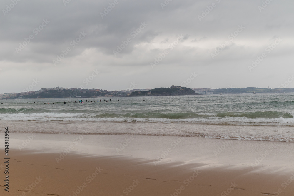 Surfing afternoon in a cloudy day with friends, Cantabria,  Spain