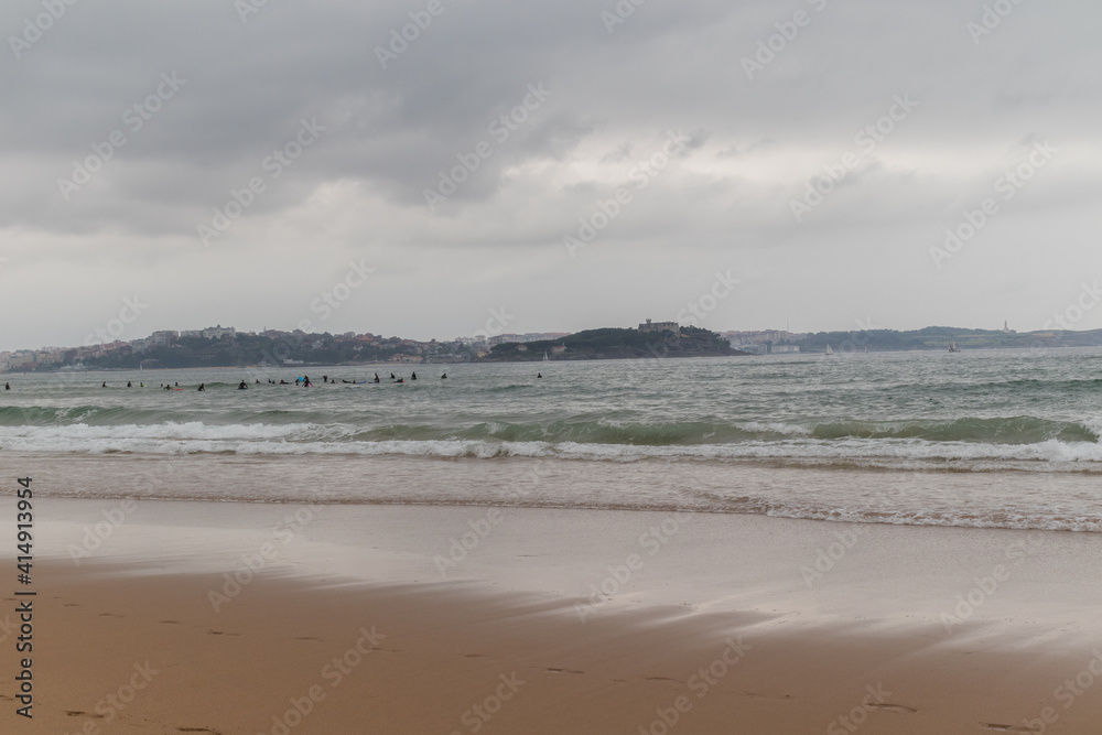 Surfing afternoon in a cloudy day with friends, Cantabria, Spain Surfing afternoon in a cloudy day with friends, Cantabria, Spain