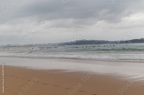 Surfing afternoon in a cloudy day with friends, Cantabria, Spain