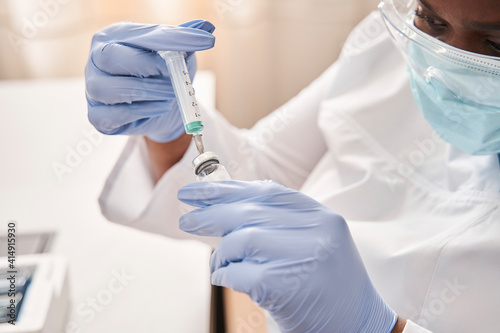 Nurse holding in hands ampoule with coronavirus vaccine