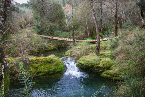 River in the forest of Beselga, Portugal. Forest with moss covered rocks and trees with river stream