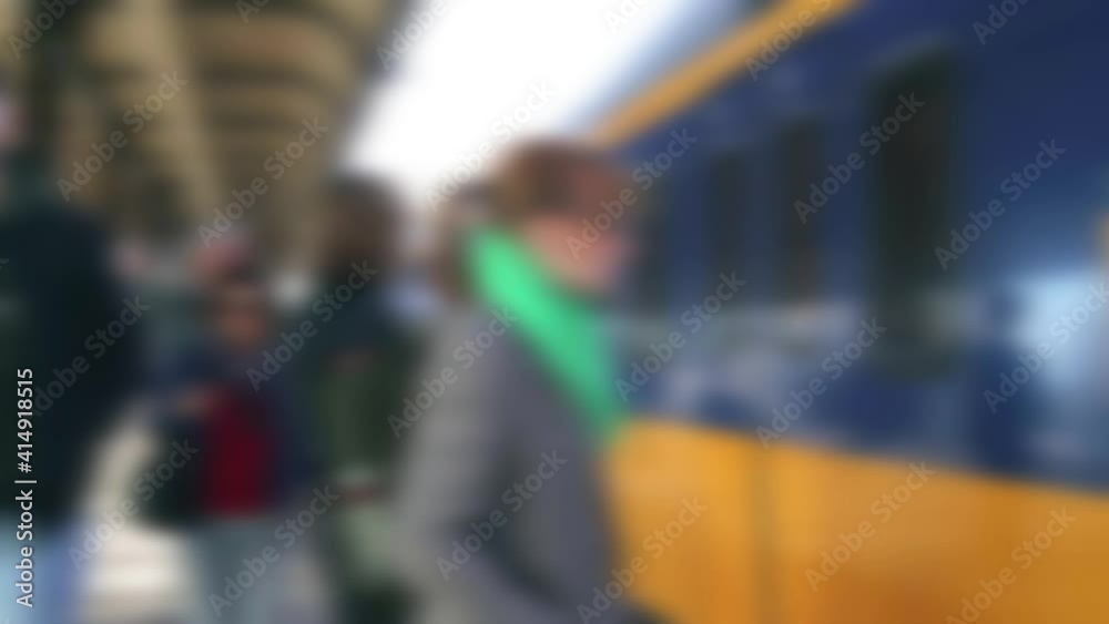 Abstract blurred Passengers on platform waiting for train to stop Abstract blurred Passengers on platform waiting for train to stop