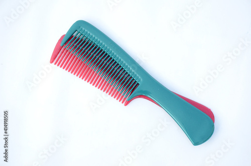 the pair of maroon blue color comb isolated on white background.