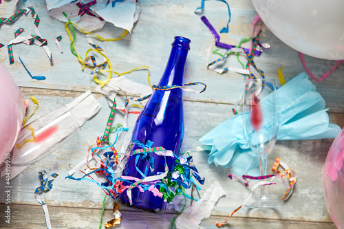 Canvas Print Top view of floor with after a party celebration with empty blue bottles, wine g