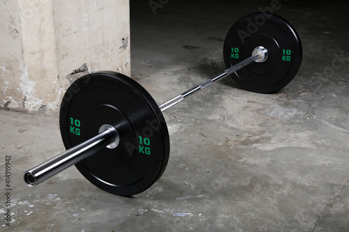 Barbell bar and barbell plate on black background photo